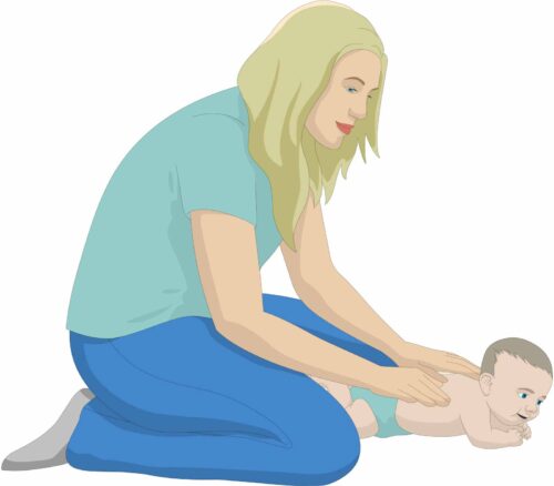 Mother massaging her baby