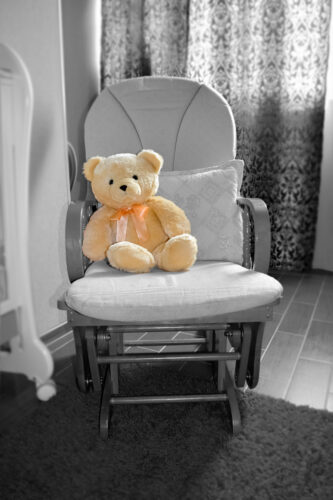 teddy bear on baby glider