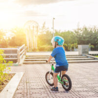 child riding on a balance bike