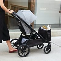 baby jogger city select lux pushed down the street by mom