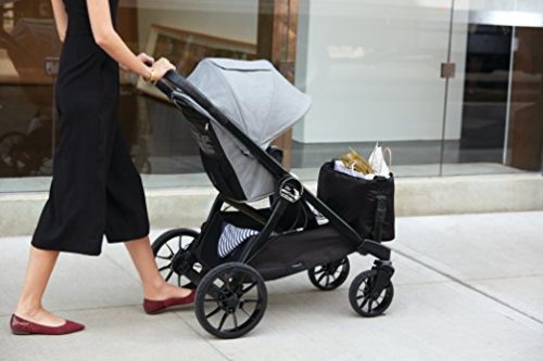 baby jogger city select lux pushed down the street by mom