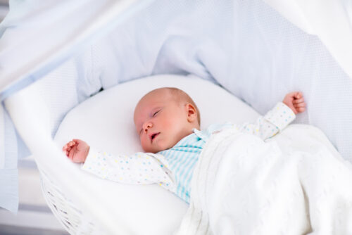 baby laying in bassinet