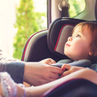 child sitting in a car seat