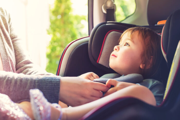 child sitting in a car seat