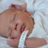 Sleeping baby with hospital bracelet