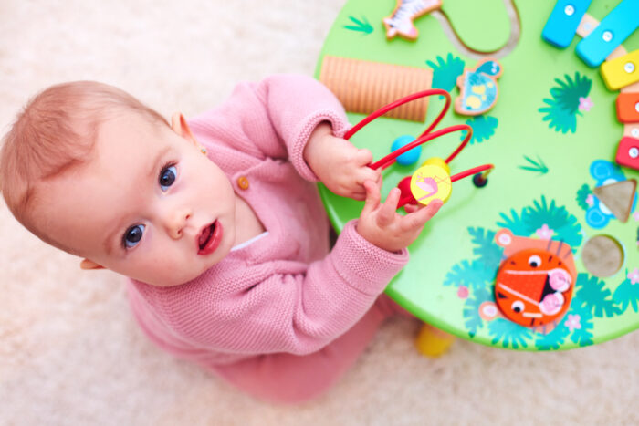 baby playing with activity table