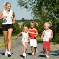 3 girls running with mom in sneakers