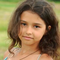 8 year old, brown haired girl in field