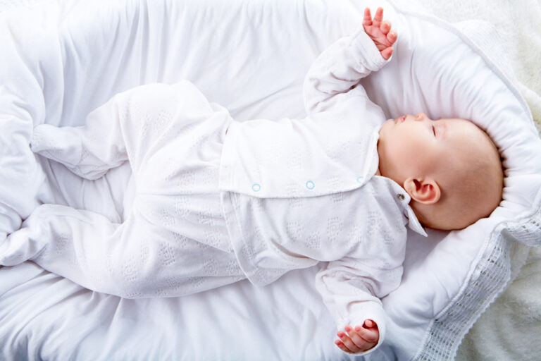 baby sleeping in a baby cradle