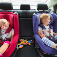 twin babies in side by side car seats