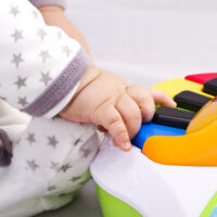 toddler playing a piano toy