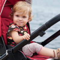 Cute little girl sitting up in stroller