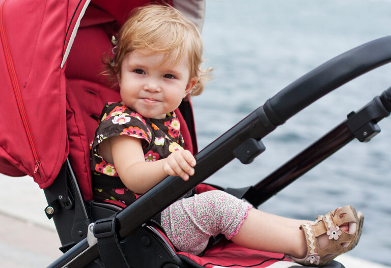 Cute little girl sitting up in stroller