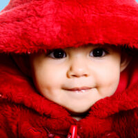 Baby in furry coat due to cold weather