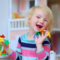 Preschool girl with toys on her fingers