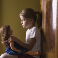 7 year old girl playing with her doll