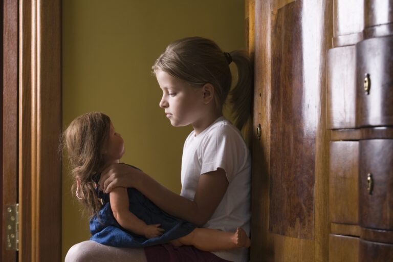 7 year old girl playing with her doll