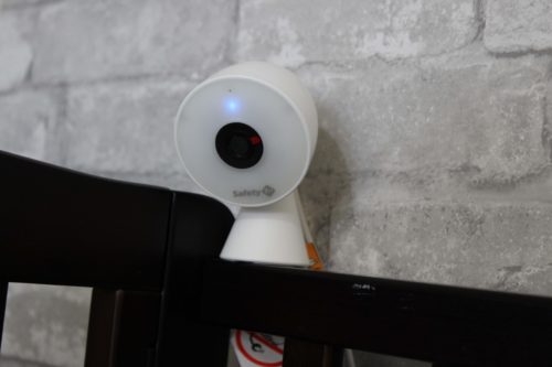 baby monitor camera sitting on crib rail
