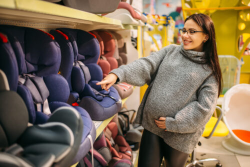 mother looking at car seats in store