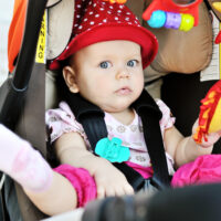 Baby chilling out in stroller with toys