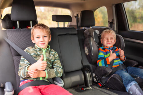 Two little boys in their booster seats