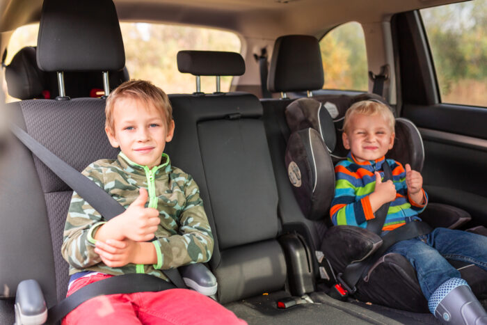 Two little boys in their booster seats