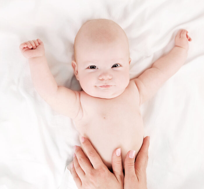 Mother massaging baby