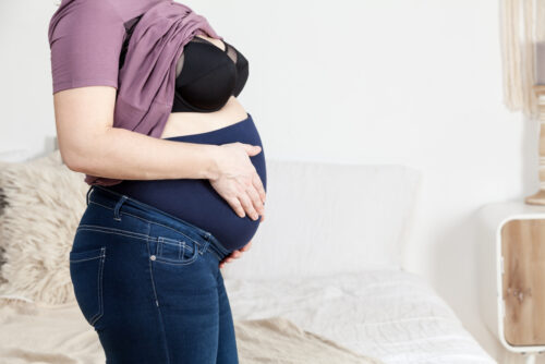 pregnant woman wearing pants with belly band