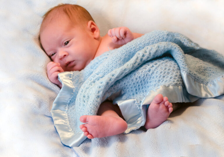 Baby wrapped in blue blanket