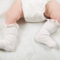 baby with white frilly socks