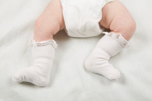 baby with white frilly socks