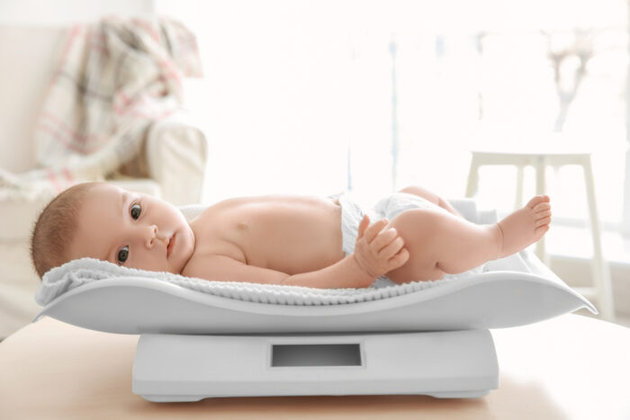 baby laying on a baby scale