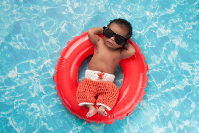 baby wearing sunglasses in the pool