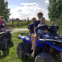 three kids on a four wheeler