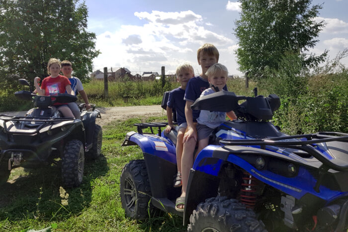 three kids on a four wheeler