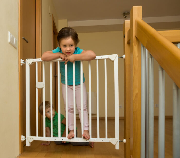 child standing on a baby gate