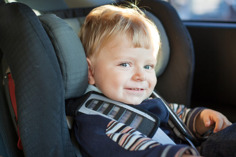 Close up of toddler boy in car seat