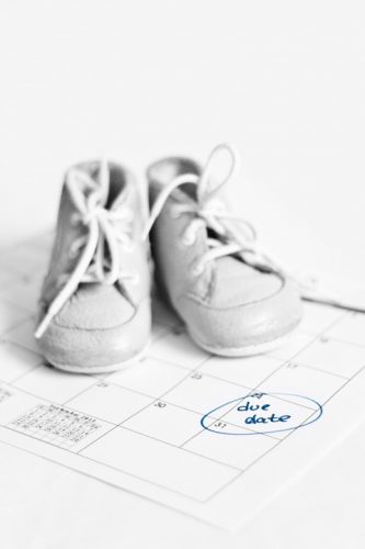 Image of baby shoes on calendar - best month to have a baby is?