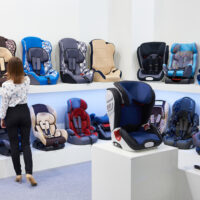 Mom looking at displays of car seats in store