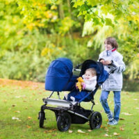 woman pushing a stroller outside