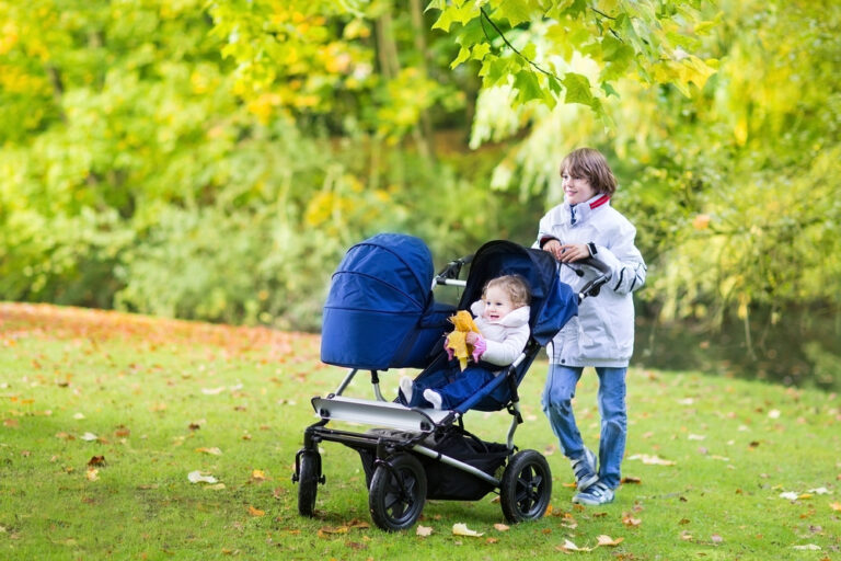 woman pushing a stroller outside