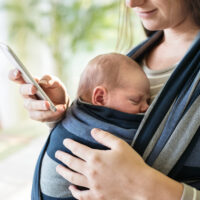 baby facing mom in a baby carrier wrap