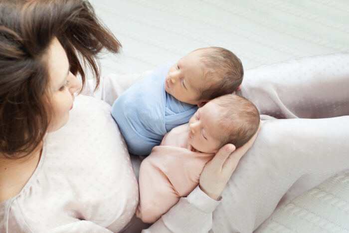 woman holding twin babies