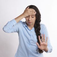 mom holding hand up saying stop