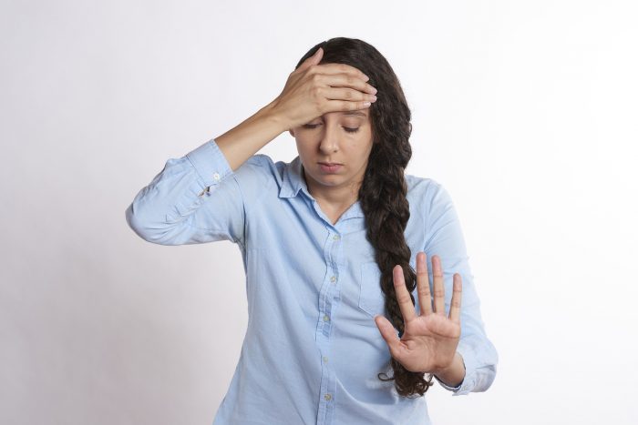 mom holding hand up saying stop