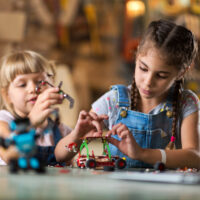 two girls playing with building set