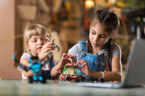 two girls playing with building set