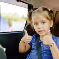 Little girl in high back car seat