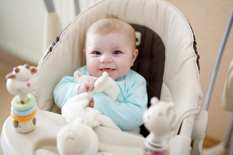 baby sitting in baby swing