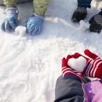 toddler hands with gloves in snow